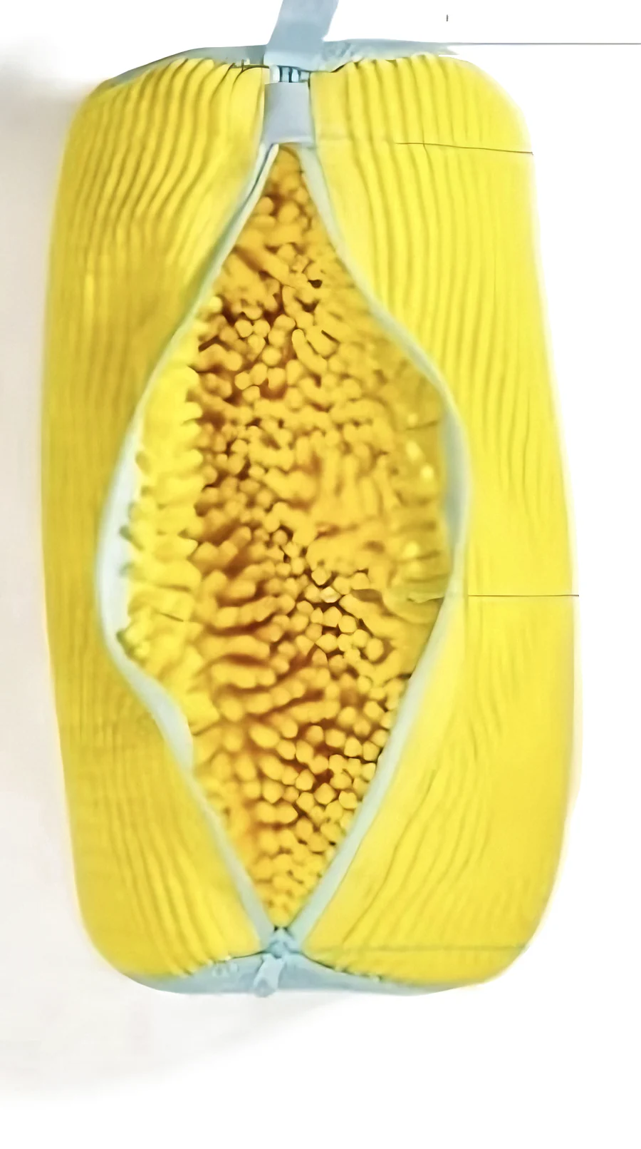 The bag unzipped lengthwise, packed with thick yellow chenille fibers