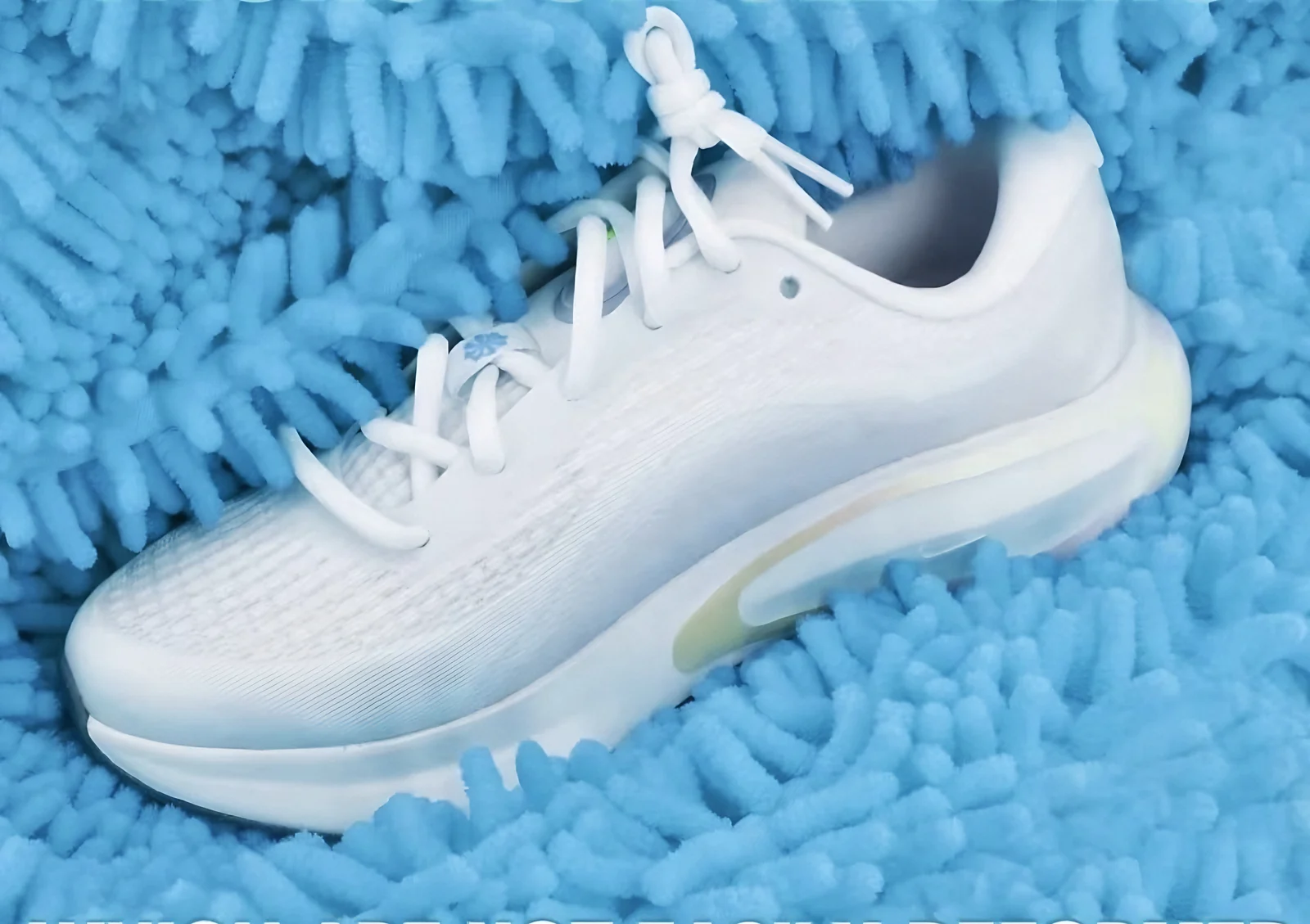 A white running shoe nestled in sky blue chenille fibers